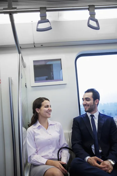 Business people chatting on the subway