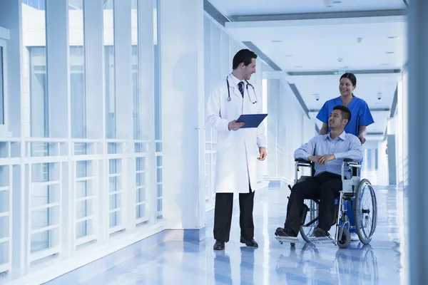 Nurse assisting patient in a wheelchair