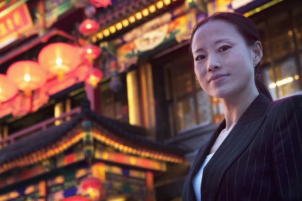 Businesswoman with Chinese architecture