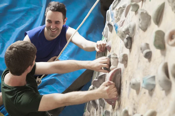 Men climbing in an indoor climbing gym