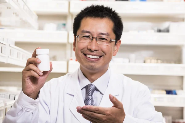 Pharmacist holding a prescription medication bottle