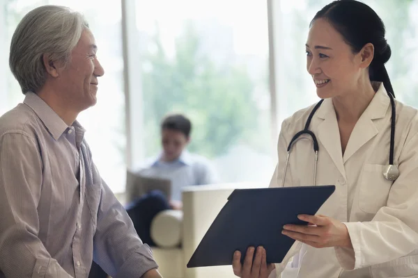 Doctor and patient discussing medical record