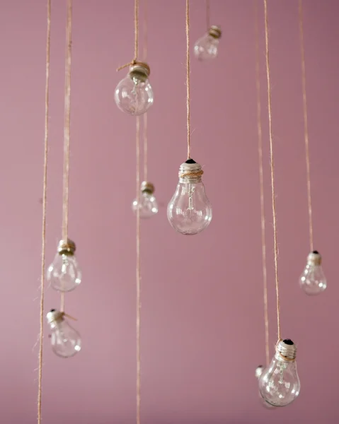 Beautiful retro light bulbs decoration in the room with violet wall