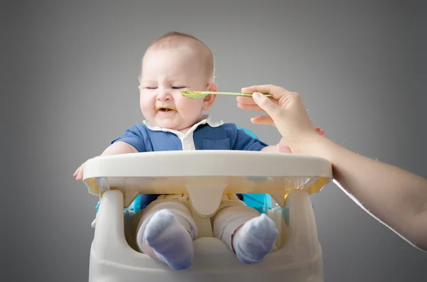 Meal Time. Funny baby refuses to eat. High definition image.