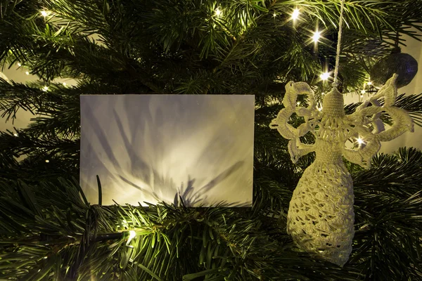 Blank Christmas Card with Angel toy on Christmas Tree