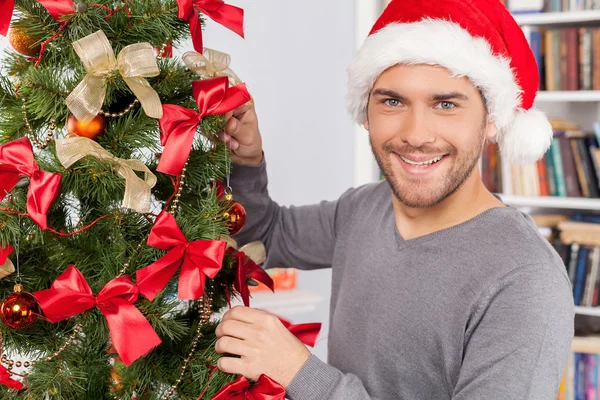 Man decorating a Christmas tree