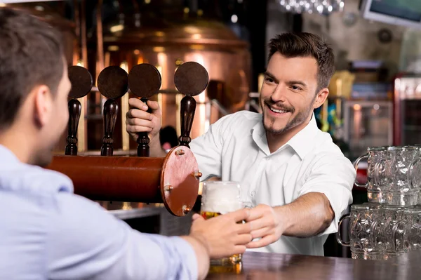 Bartender giving beer