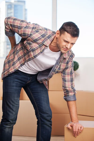 Young man holding hand on his back