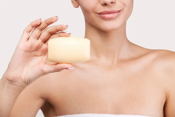 Young woman holding a soap bar