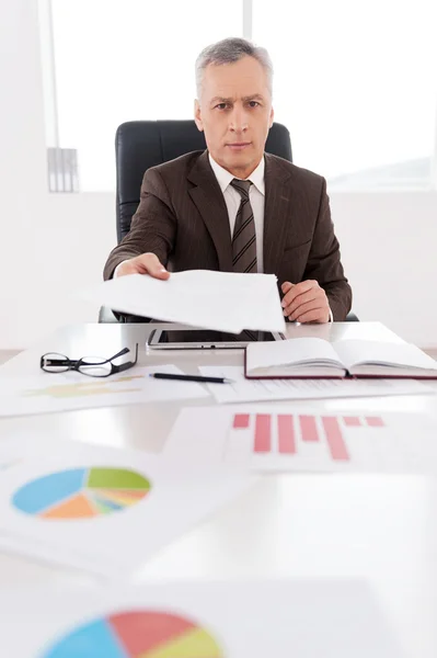 Man stretching out documents to sign