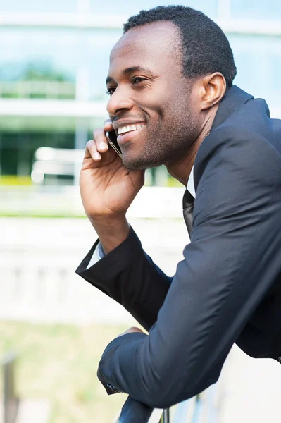 African man in formal wear talking on the mobile phone