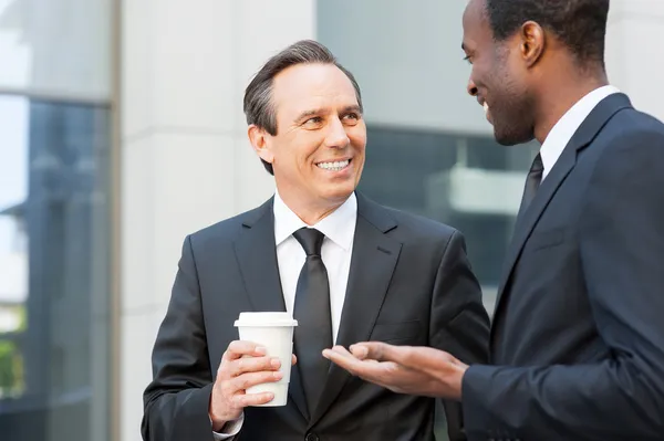 Businessmen talking with coffee cup