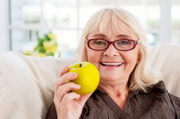 Senior woman holding apple