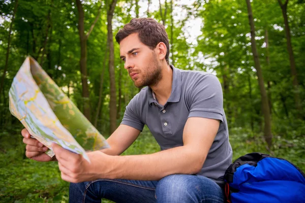 Young man with examining map