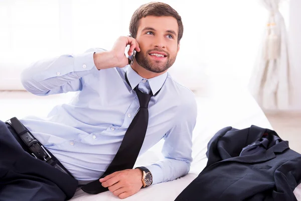 Man in shirt and tie talking on phone