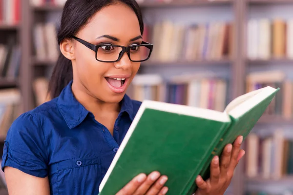 African female student reading a book