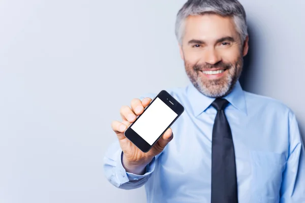 Happy businessman with mobile phone.