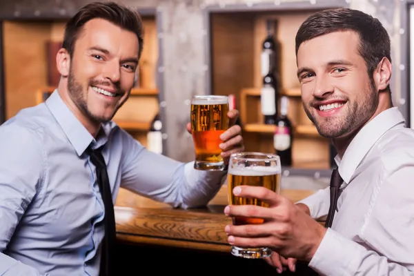 Men holding glasses with beer