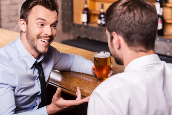 Men drinking beer at the bar counter
