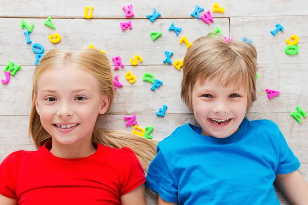 Children with plastic colorful letters