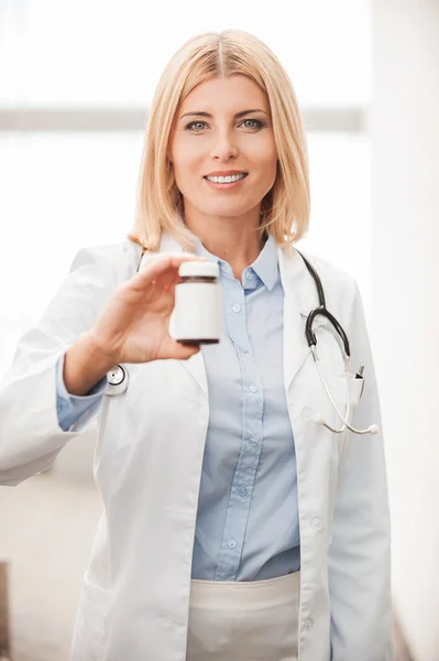 Female doctor holding container with medicines