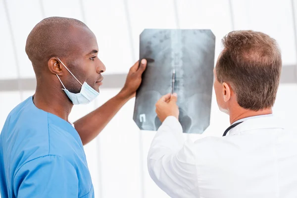 Doctors consulting about x-ray.