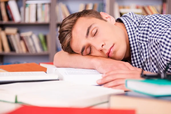 Handsome young man sleeping in library