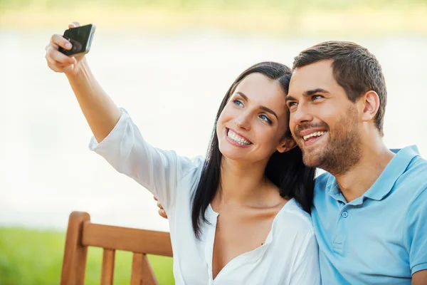 Loving couple making selfie with mobile phone