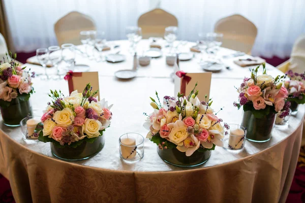 Wedding table with flowers arrangements
