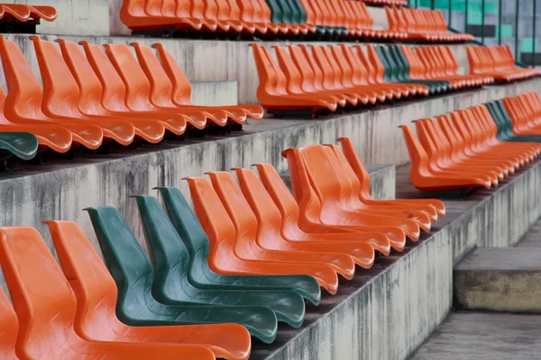 Rows of red mini-football stadium empty seats