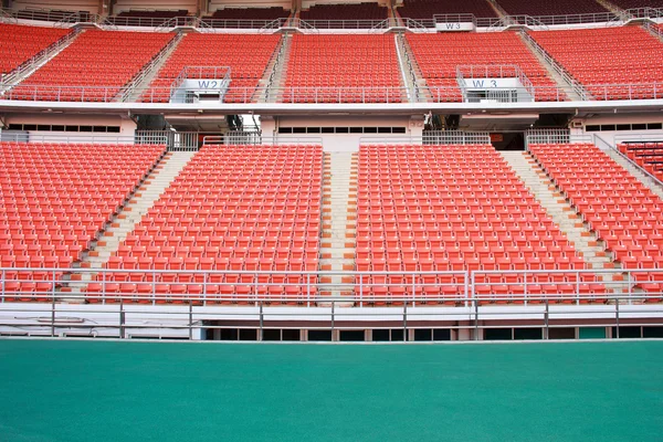 Rows of red mini-football stadium empty seats