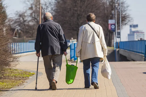 Old Couple Walking with Shopping Bags