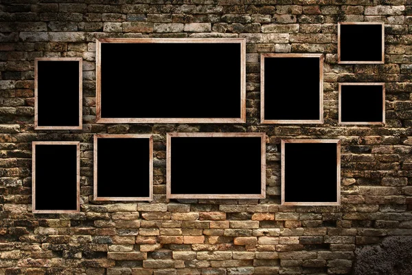 Old  photo frames on old brick wall texture, grunge industrial interior