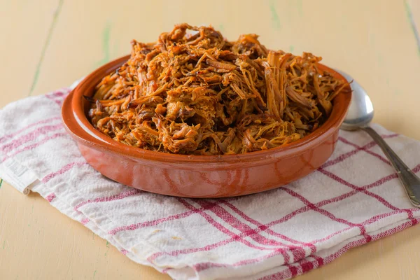 Plate filled with pulled pork on a round dish