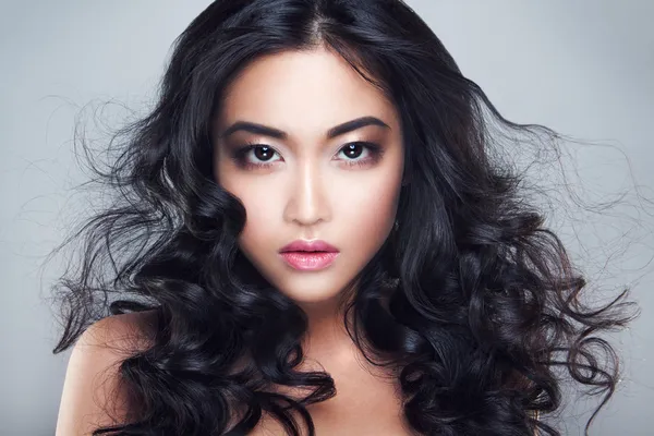 Young and beautiful asian woman with curly hair