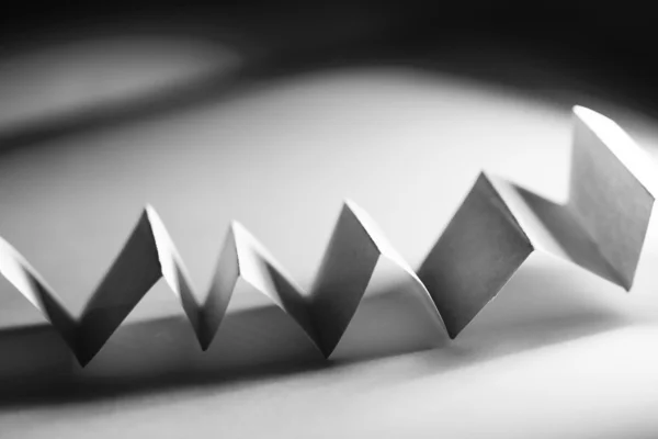 Picture of a orange zig-zag paper on paper background