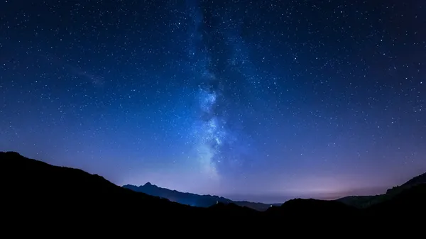 Night sky stars. Milky Way. Mountain background