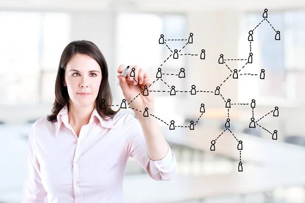 Young business woman drawing Social Network Concept. Office background.