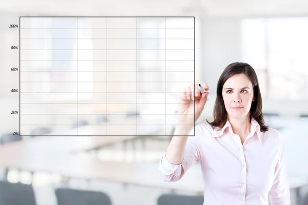 Young business woman drawing on empty graph. Office background.