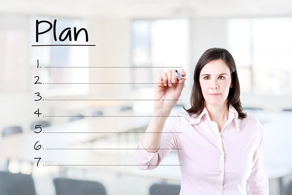 Business woman writing blank plan list. Office background.