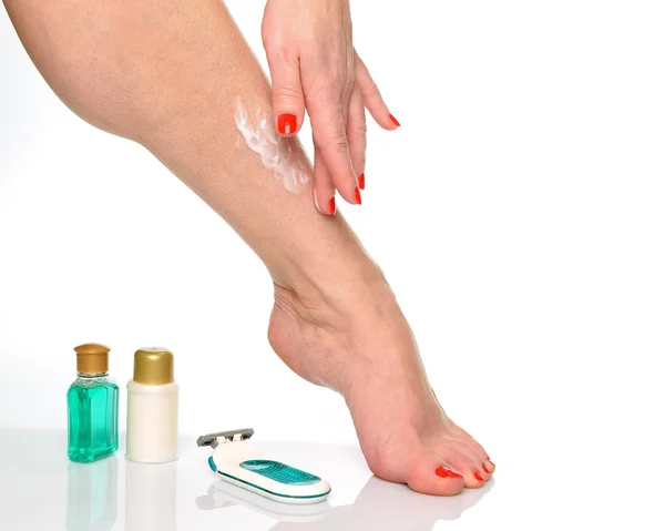 Female legs and items for foot care and body care
