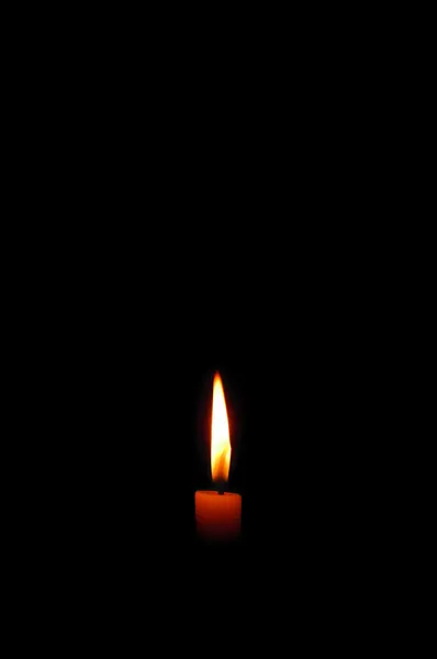 Candle burning in the dark