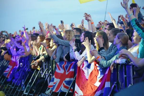 People crowd with british flags