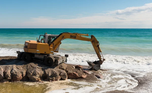 Backhoe Working By The Sea