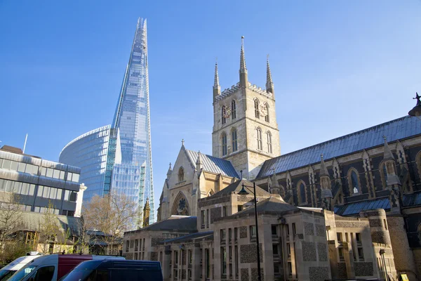 LONDON, UK - MARCH 29, 2014 Southwark Cathedral and Shadr of glass South bank walk of the river Thames Contrast modern and old arhitecture