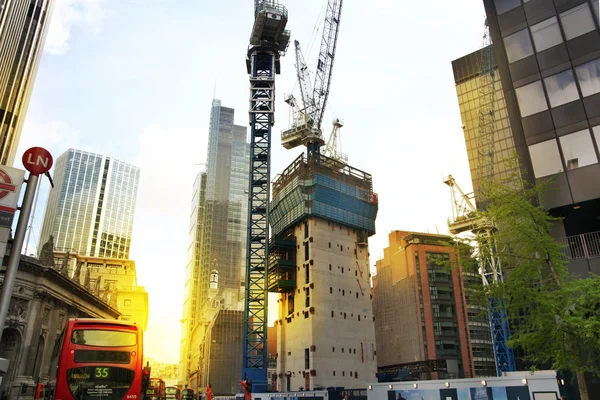 LONDON, UK - APRIL 24, 2014: Building site with cranes in the City of London one of the leading centres of global finance.