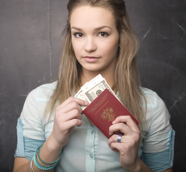 Portrait of cute girl student with money and passport