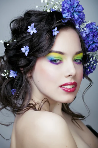 Beauty young woman with flowers and make up close up