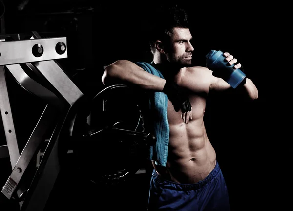 Young male bodybuilder doing heavy weight exercise