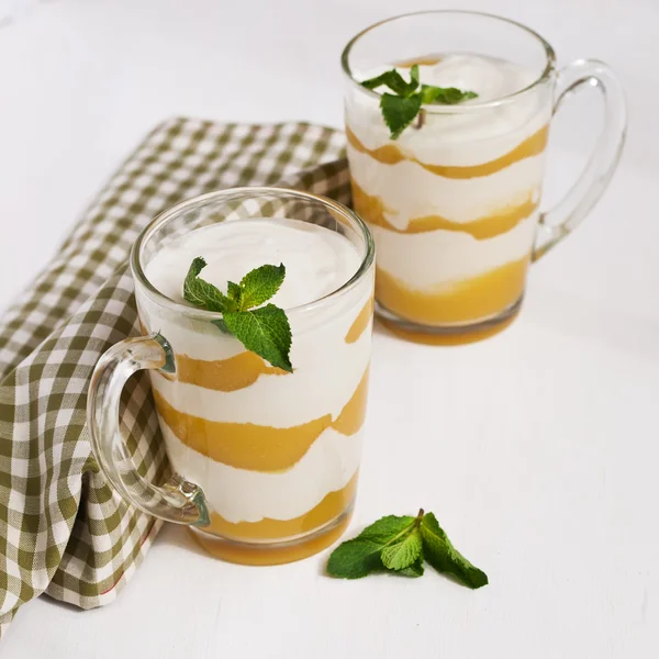 Homemade  cream with peach and mint on white